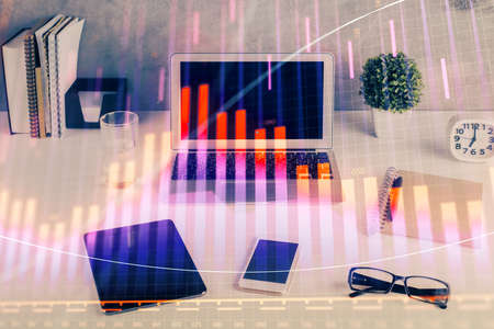 Forex market chart hologram and personal computer background. Multi exposure. Concept of investment.の写真素材