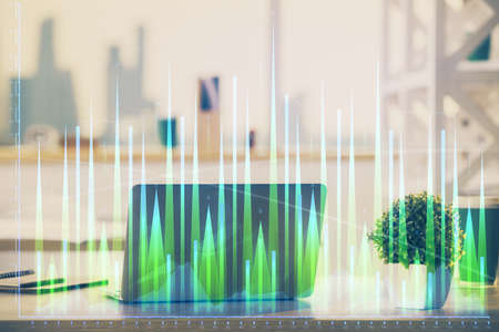 Stock market graph and table with computer background. Multi exposure. Concept of financial...