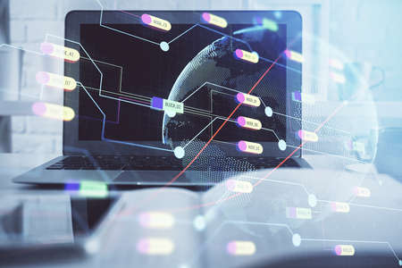 Multi exposure of table with computer and world map hologram. International data network concept.