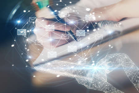 E-mail abstract envelop drawing over hands taking notes background. Concept of electronic mail. Double exposureの写真素材