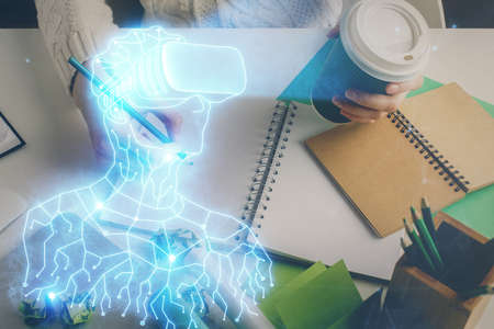 AR hologram over woman's hands taking notes background. Concept of augmented reality. Multi exposure