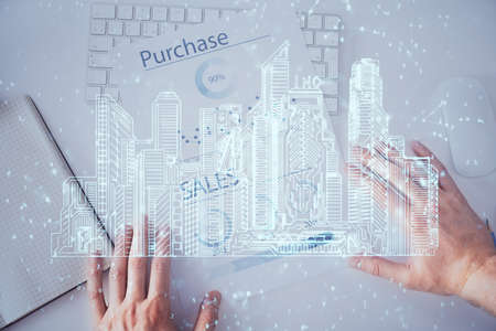 Abstract holographic city on man's hand writing notes background. Multi exposure.の写真素材