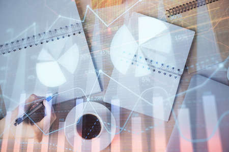 Multi exposure of woman's hands making notes with forex graph hologram. Concept of technical analysis.の写真素材