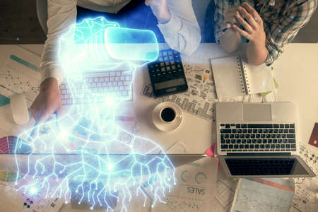 Double exposure of man and woman working together and man in virtual glasses hologram drawing....