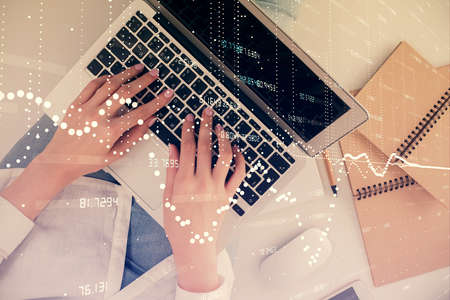 Double exposure of woman hands working on computer and data theme hologram drawing. Top View. Technology concept.の写真素材