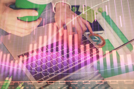 Double exposure of woman hands typing on computer and forex chart hologram drawing. Stock market...