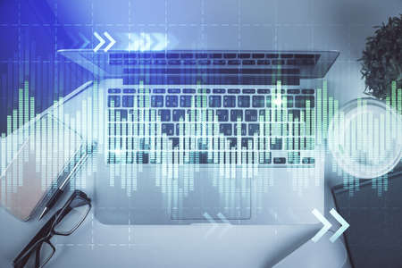 Multi exposure of financial chart drawing over table background with computer. Concept of research....