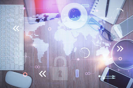 Double exposure of map hologram drawing over desktop. Top view. International connection concept.