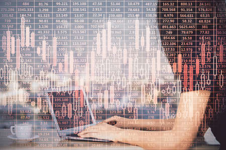 Double exposure of businesswoman hands typing on computer and forex chart hologram drawing....