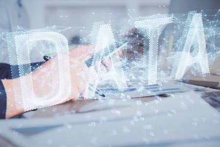 Multi exposure of man's hands holding and using a digital device and data theme drawing. Innovation concept.の写真素材