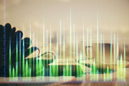 Double exposure of financial chart drawing and desktop with coffee and items on table background....