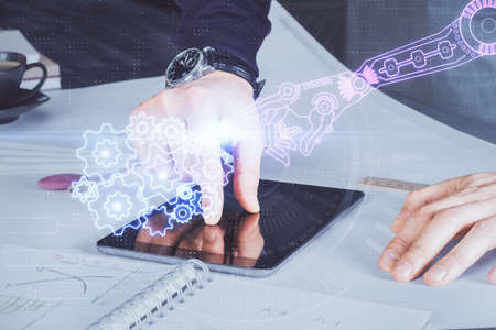 Double exposure of man's hand holding and using a digital device and data theme drawing. Technology...