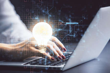 Double exposure of woman hands typing on computer and light bulb drawing. Idea concept.