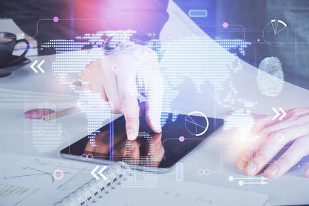 Multi exposure of man's hands holding and using a digital device and map drawing. International...