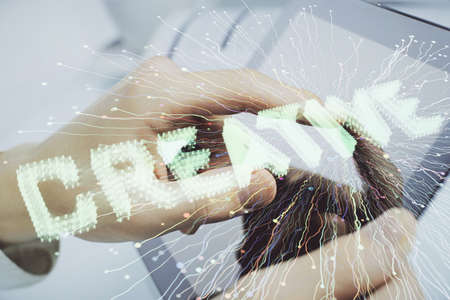 Double exposure of man's hands holding and using a mobile device and creative hologram drawing.の写真素材