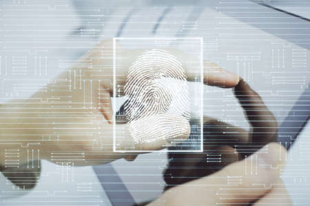 Double exposure of man's hands holding and using a digital device and fingerprint hologram drawing. Security concept.の写真素材