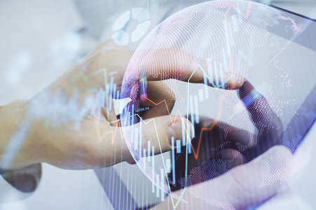 Multi exposure of man's hands holding and using a phone and financial chart drawing. Market analysis...