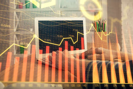 Double exposure of woman hands typing on computer and forex chart hologram drawing. Stock market invest concept.の写真素材