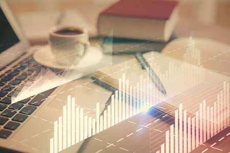 Double exposure of forex chart drawing and desktop with coffee and items on table background....