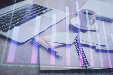 Multi exposure of forex graph drawing and desktop with coffee and items on table background. Concept...