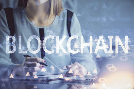Double exposure of woman hands typing on computer and crypto market theme hologram drawing. Blockchain concept.の写真素材