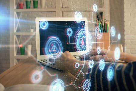 Double exposure of woman hands working on computer and data theme hologram drawing. Tech concept.