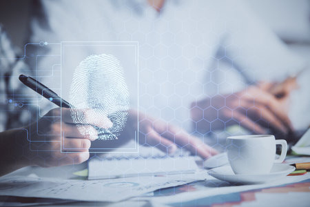 Double exposure of fingerprint drawing over people taking notes background. Concept of securityの写真素材