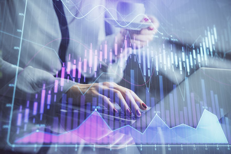Double exposure of businesswoman hands typing on computer and financial graph hologram drawing. Stock market analysis concept.の写真素材