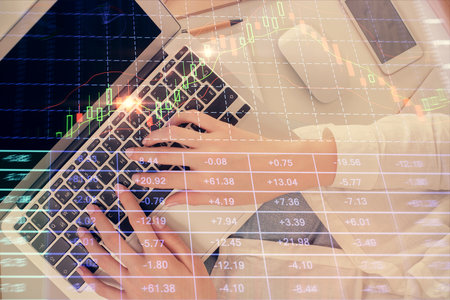 Double exposure of woman hands working on computer and forex chart hologram drawing. Top View....