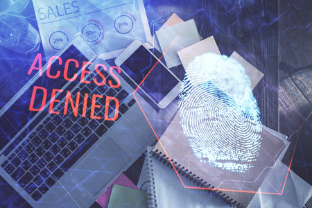Finger print over computer on the desktop background. Top view. Double exposure. Concept of securitization.の写真素材
