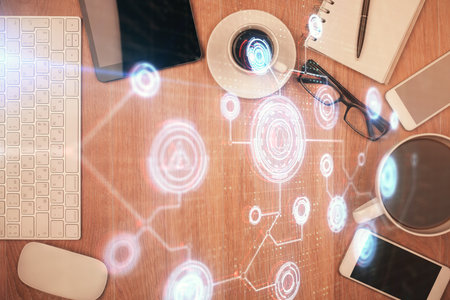 Double exposure of technology theme drawing over work table desktop. Top view. Global data analysis...