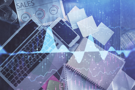 Financial market graph and top view computer on the desktop background. Multi exposure. Investment concept.の写真素材
