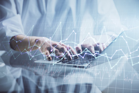 Double exposure of woman hands typing on computer and forex chart hologram drawing. Stock market...