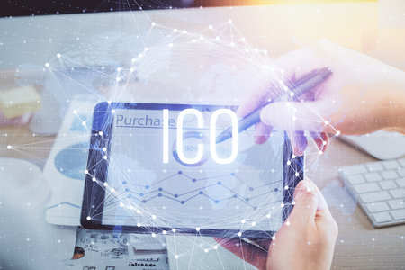 Double exposure of man's hands holding and using a phone and crypto currency blockchain theme...