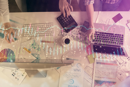 Multi exposure of man and woman working together and financial chart hologram. Business concept. Computer background.の写真素材