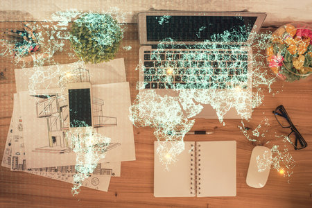 Social network hologram drawings over computer on the desktop background. Top view. Double exposure.の写真素材