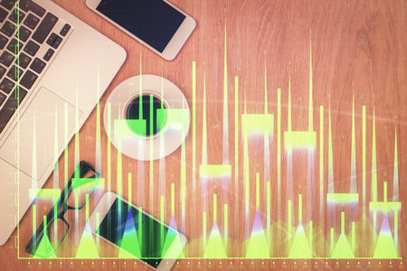Double exposure of forex chart hologram over desktop with phone. Top view. Mobile trade platform concept.の写真素材