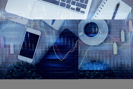 Double exposure of financial chart hologram over desktop with phone. Top view. Mobile trade platform concept.の写真素材