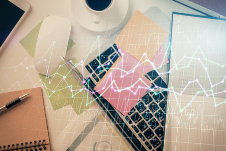 Multi exposure of financial chart drawing over table background with computer. Concept of research and analysis. Top view.の写真素材