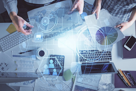 Double exposure of man and woman working together and social network theme hologram drawing. Computer background. connecting concept. Top View.の写真素材