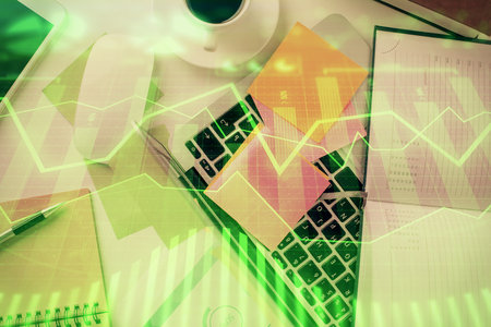 Multi exposure of financial chart drawing over table background with computer. Concept of research and analysis. Top view.の写真素材