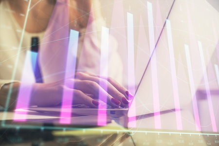 Multi exposure of woman hands typing on computer and financial graph hologram drawing. Stock market analysis concept.の写真素材