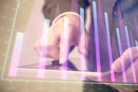 Multi exposure of man's hands holding and using a phone and financial chart drawing. Market analysis concept.の写真素材