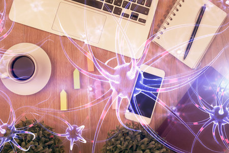 Double exposure of neuron drawing over table with phone. Top view. Science education concept.