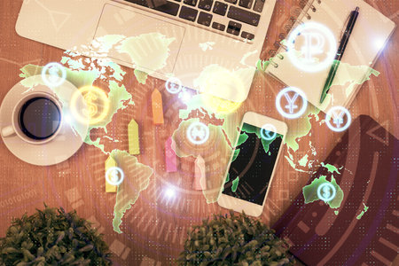 Double exposure of financial chart hologram over desktop with phone. Top view. Mobile trade platform concept.の写真素材