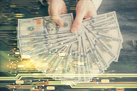 Multi exposure of technology drawing hologram and us dollars bills and man hands. Data conceptの写真素材