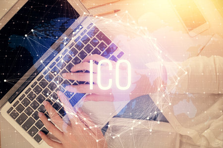 Double exposure of woman hands working on computer and blockchain theme hologram drawing. Top View. bitcoin cryptocurrency concept.の写真素材