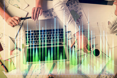 Double exposure of man and woman working together and financial graph hologram. Business concept....