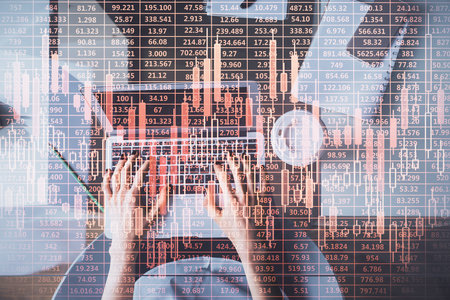 Double exposure of woman hands working on computer and forex chart hologram drawing. Top View. Financial analysis concept.の写真素材