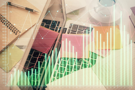 Multi exposure of financial chart drawing over table background with computer. Concept of research and analysis. Top view.の写真素材